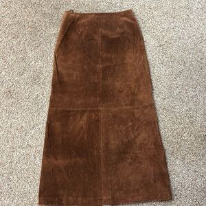 100% leather midi skirt with slit along back and zipper waist.